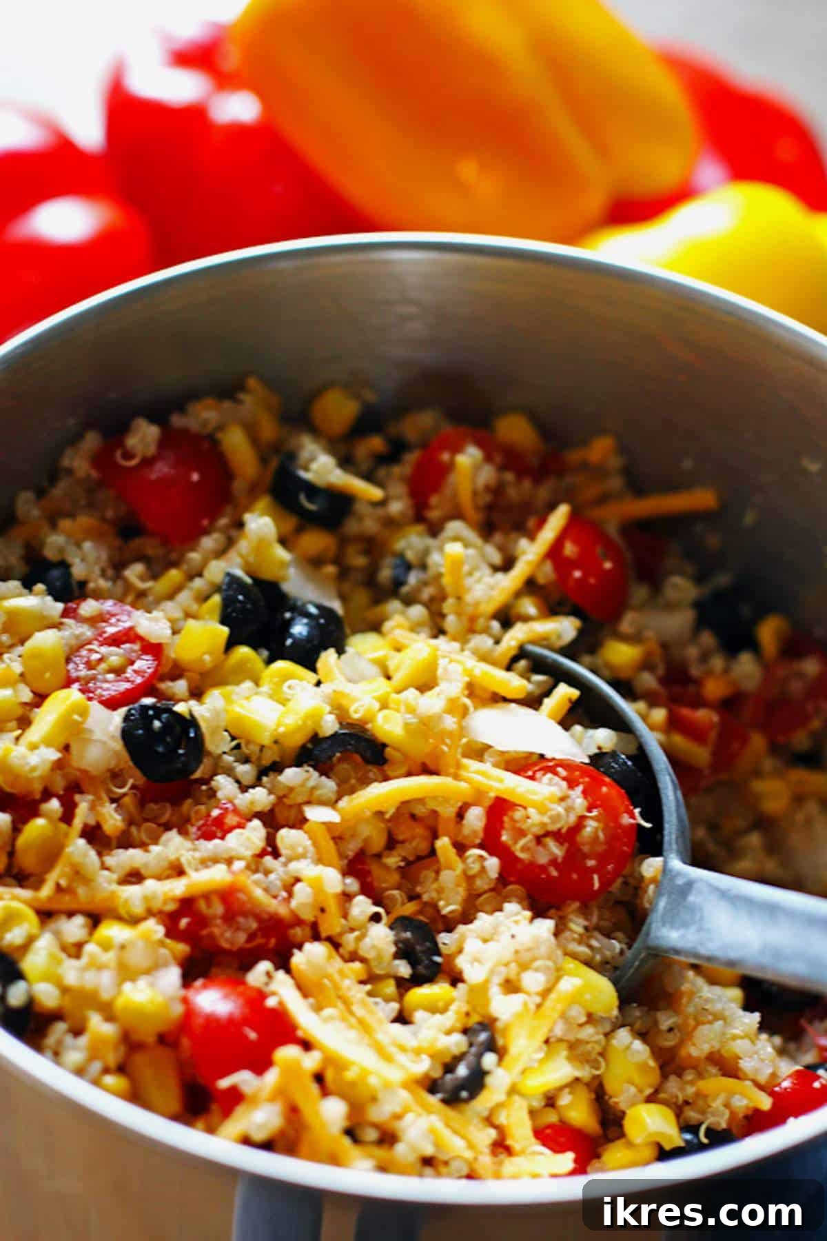 Comforting Crockpot Stuffed Peppers 4 A large bowl containing the vibrant quinoa and vegetable filling mixture for stuffed peppers.