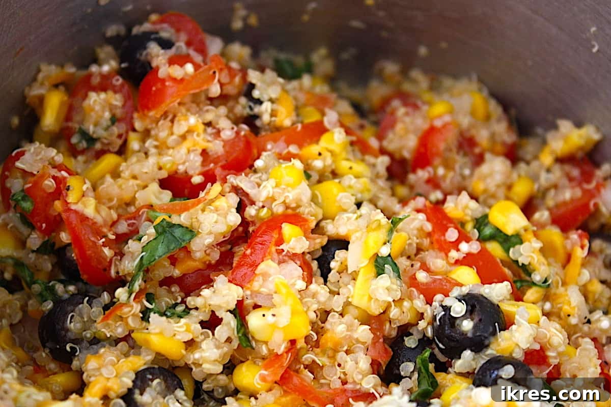 Comforting Crockpot Stuffed Peppers 5 Close-up of the seasoned quinoa and vegetable filling for crockpot stuffed peppers in a bowl, ready for assembly.