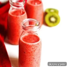 Smoothie in three glasses with sliced kiwi and a red napkin next the the glasses