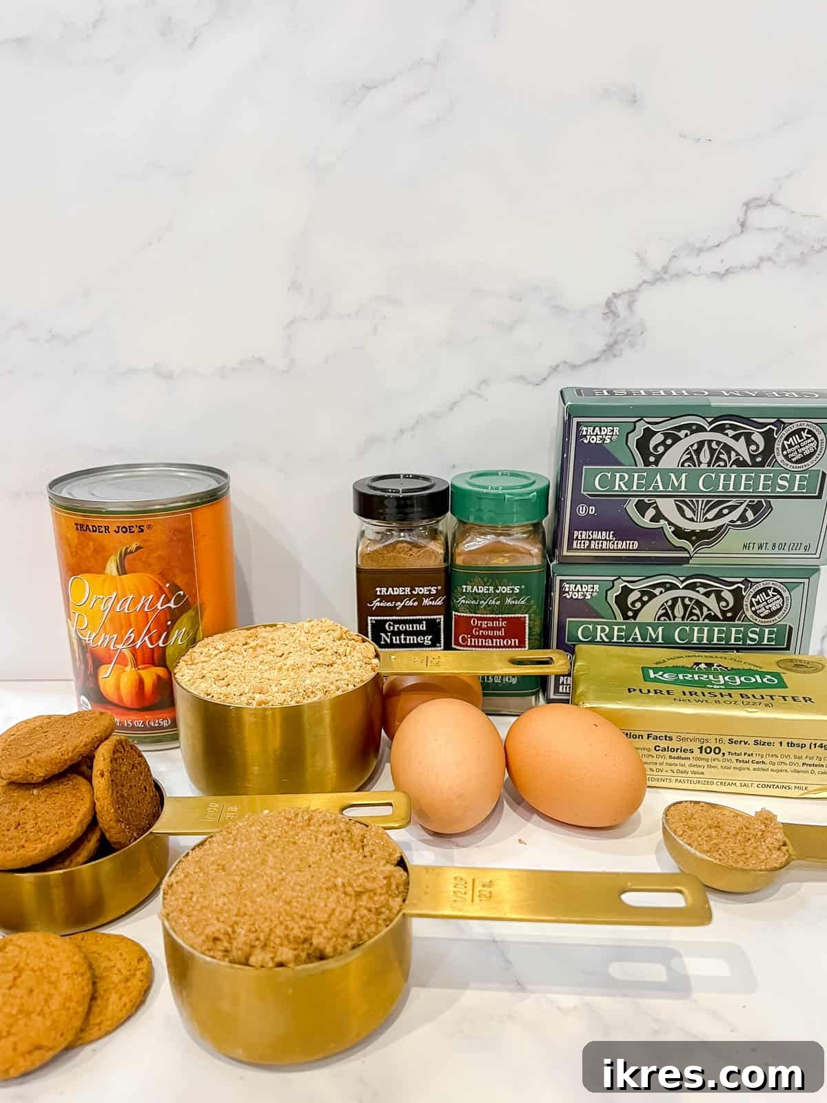 Gingersnap Crusted Pumpkin Cheesecake 3 A collection of fresh ingredients neatly arranged on a counter, essential for baking a delicious pumpkin cheesecake with gingersnap crust.