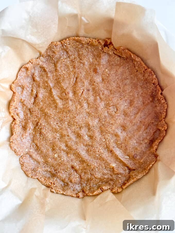 Gingersnap Crusted Pumpkin Cheesecake 5 The cheesecake crust mixture pressed firmly into a pie pan, forming an even layer.