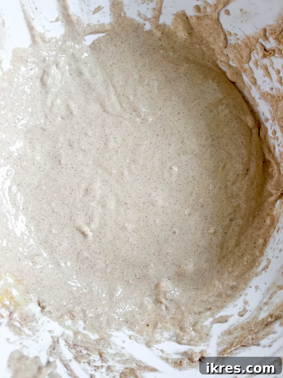 Gingersnap Crusted Pumpkin Cheesecake 8 One egg at a time being mixed into the cheesecake batter.