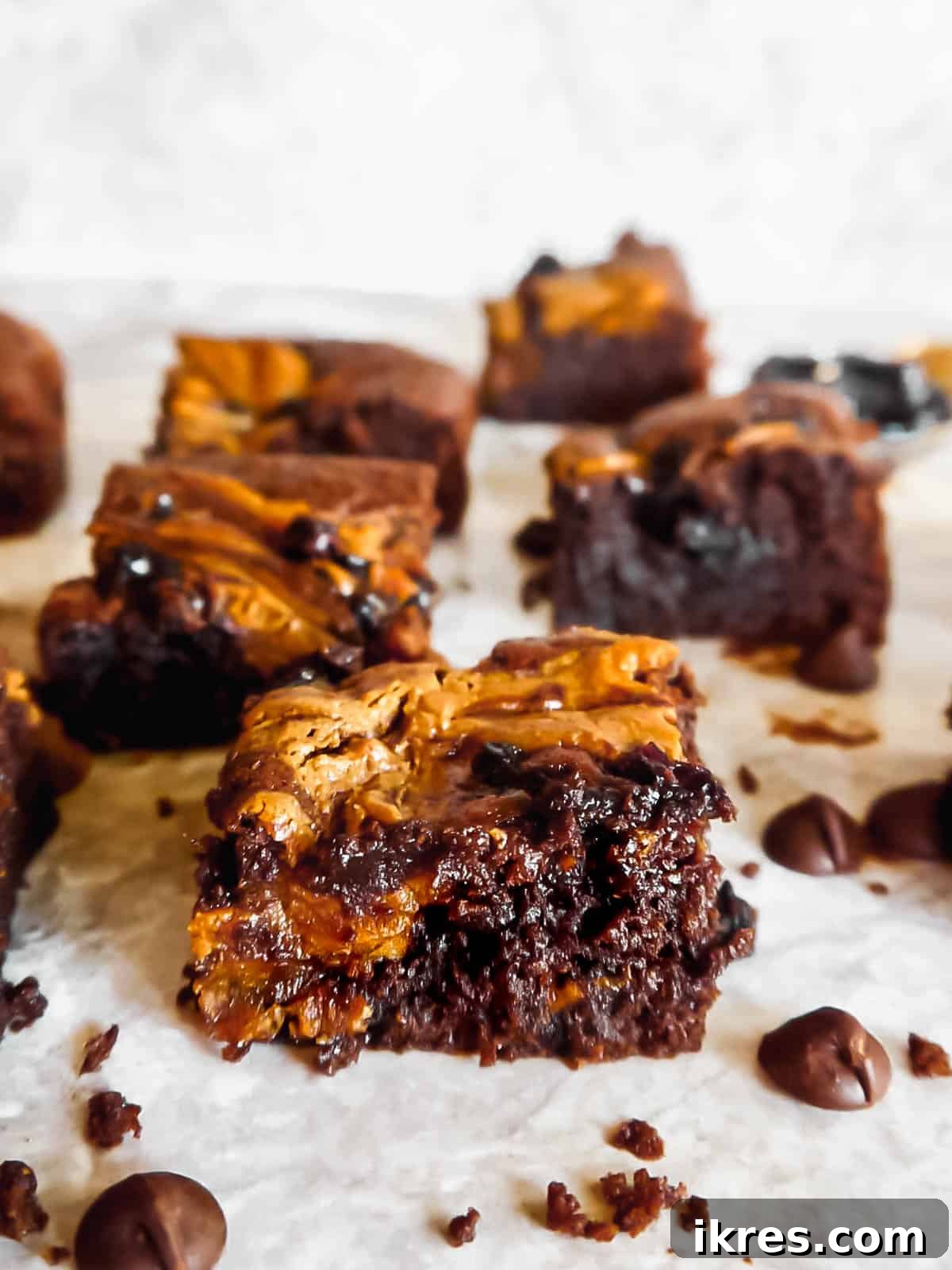 Slices of The Best Paleo Almond Butter and Jelly Brownies, showcasing fudgy texture and delicious swirls.