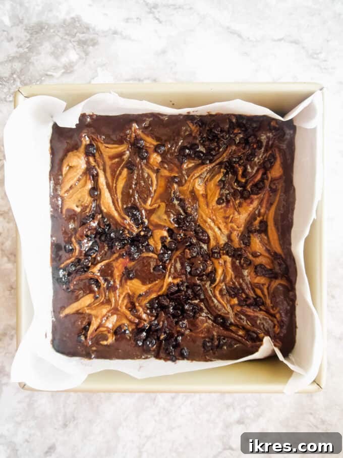 Beautiful swirls of almond butter and jelly on top of the brownie batter before baking.