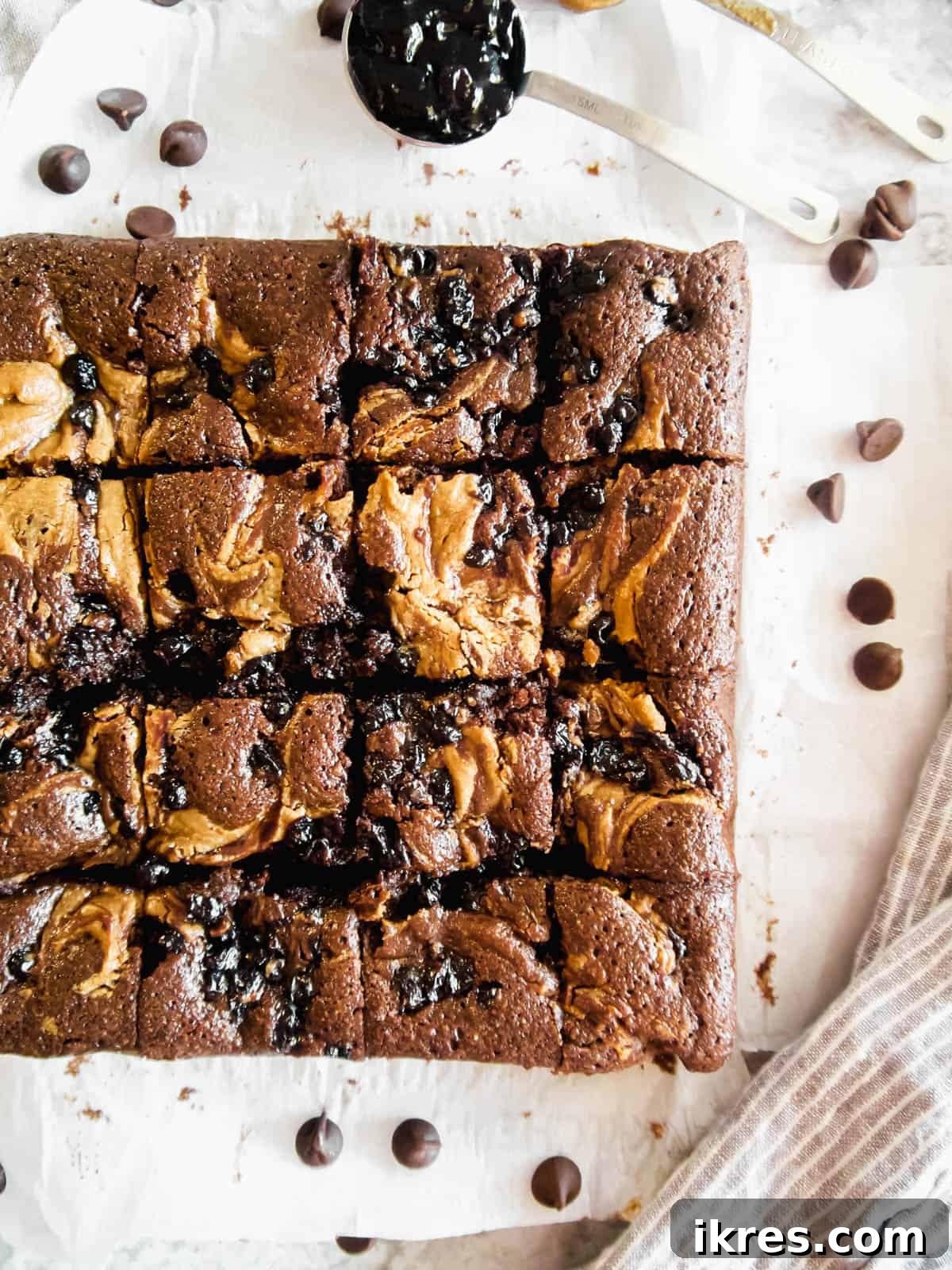 Golden brown brownies with prominent swirls of almond butter and jelly after baking.