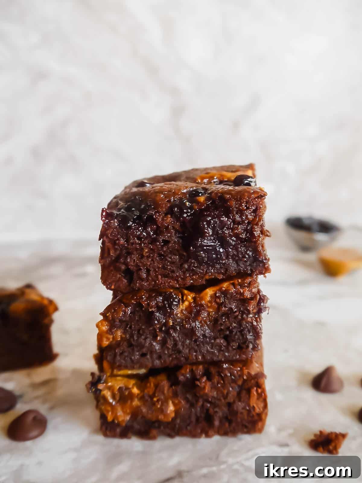 Stacked almond flour brownies with almond butter and jelly swirls, showcasing the perfect texture and delicious layers.