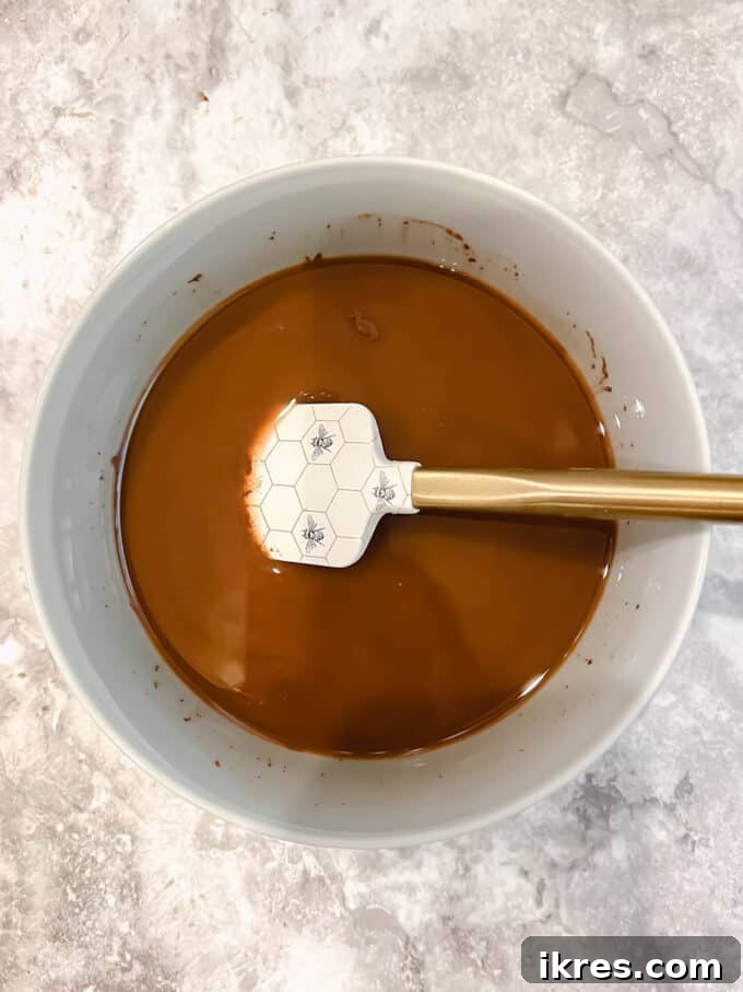 Melted dairy-free chocolate chips and olive oil in a bowl, ready for the next step.