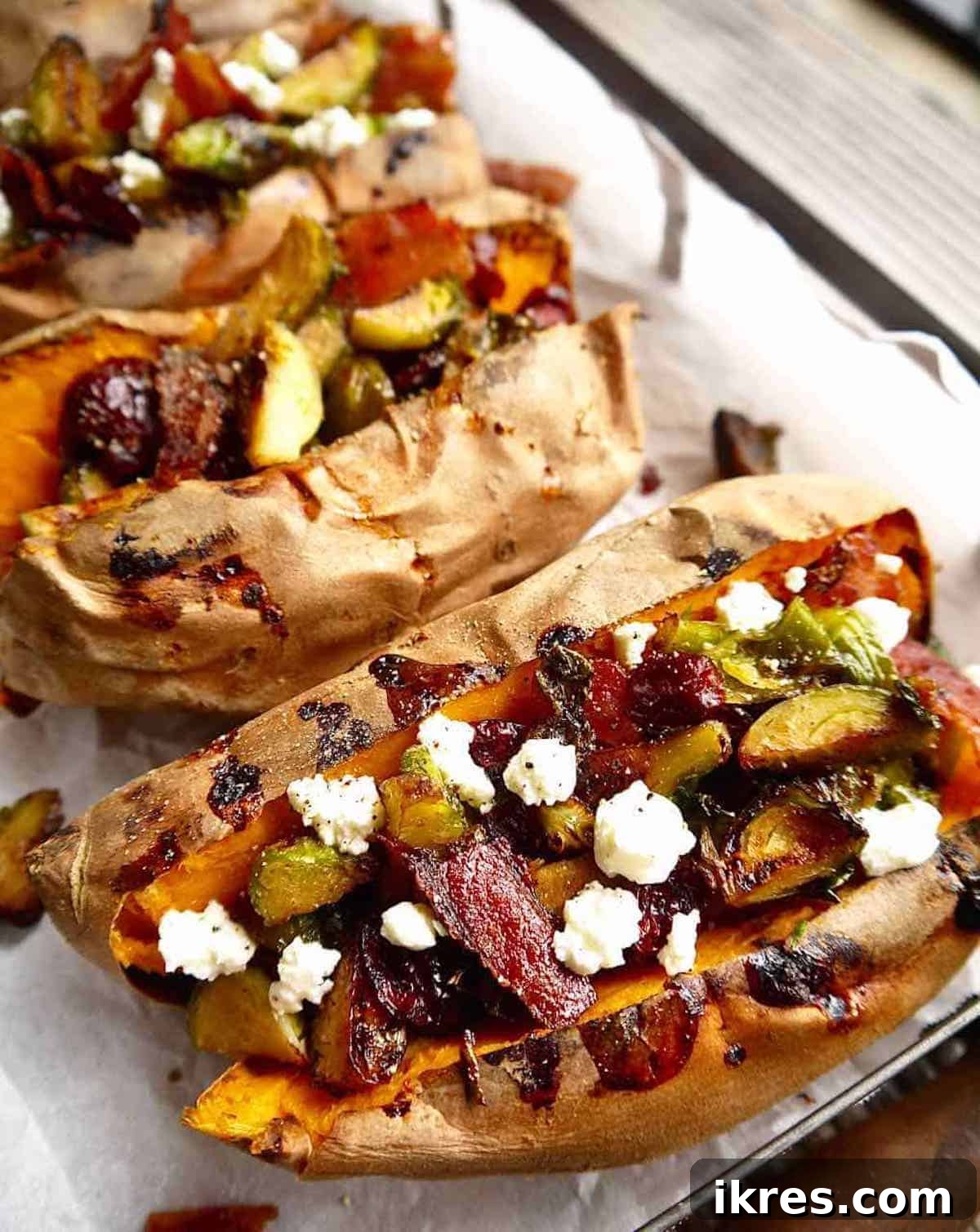 Sweet Potato Boats: Bacon, Brussels & Cranberry 3 Close up view of the flavorful filling for the stuffed sweet potatoes, featuring perfectly roasted Brussels sprouts, crumbled bacon, and plump dried cranberries in a skillet.