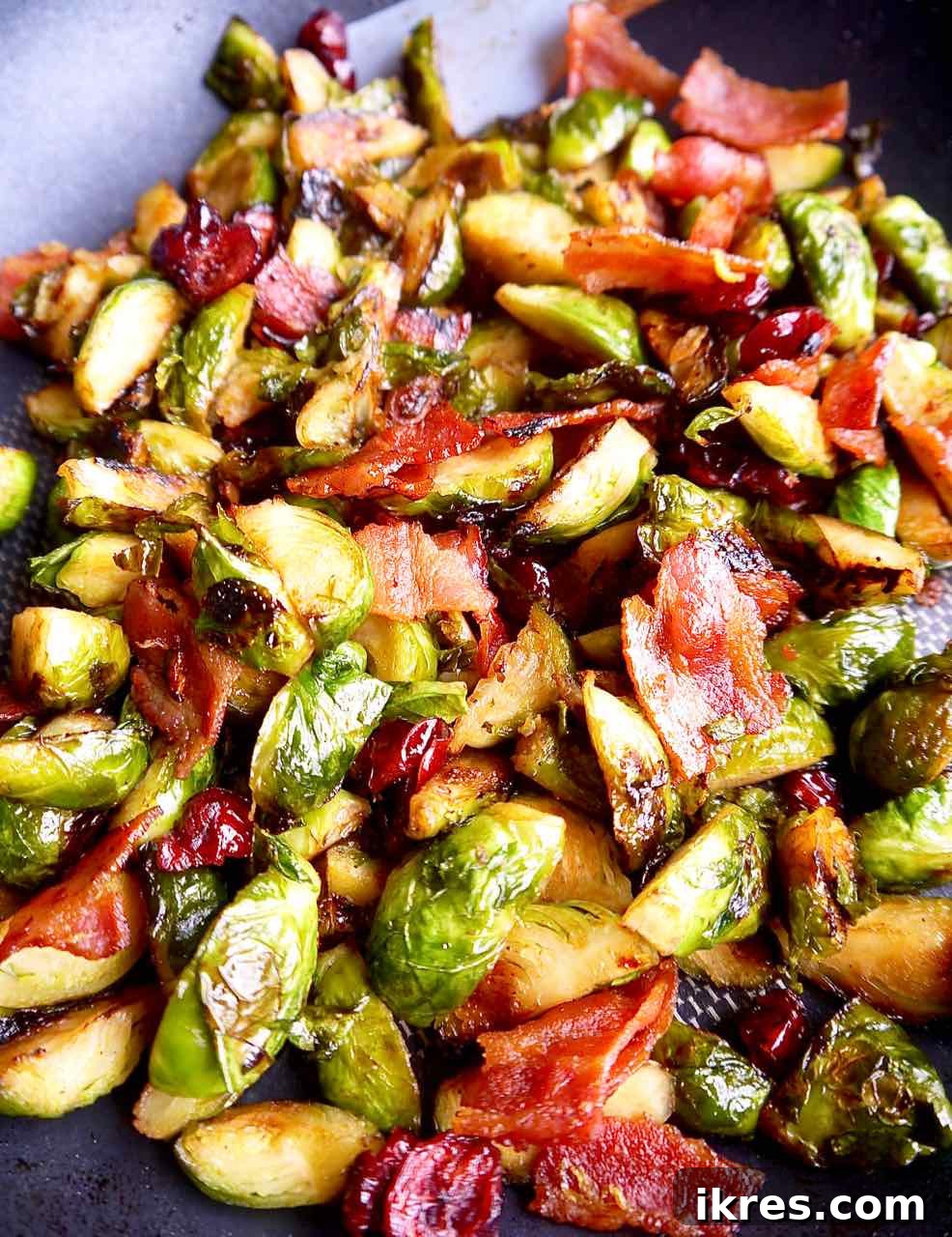 Sweet Potato Boats: Bacon, Brussels & Cranberry 4 Cooking the flavorful maple bacon Brussels sprouts and cranberry filling in a large pan on the stovetop.