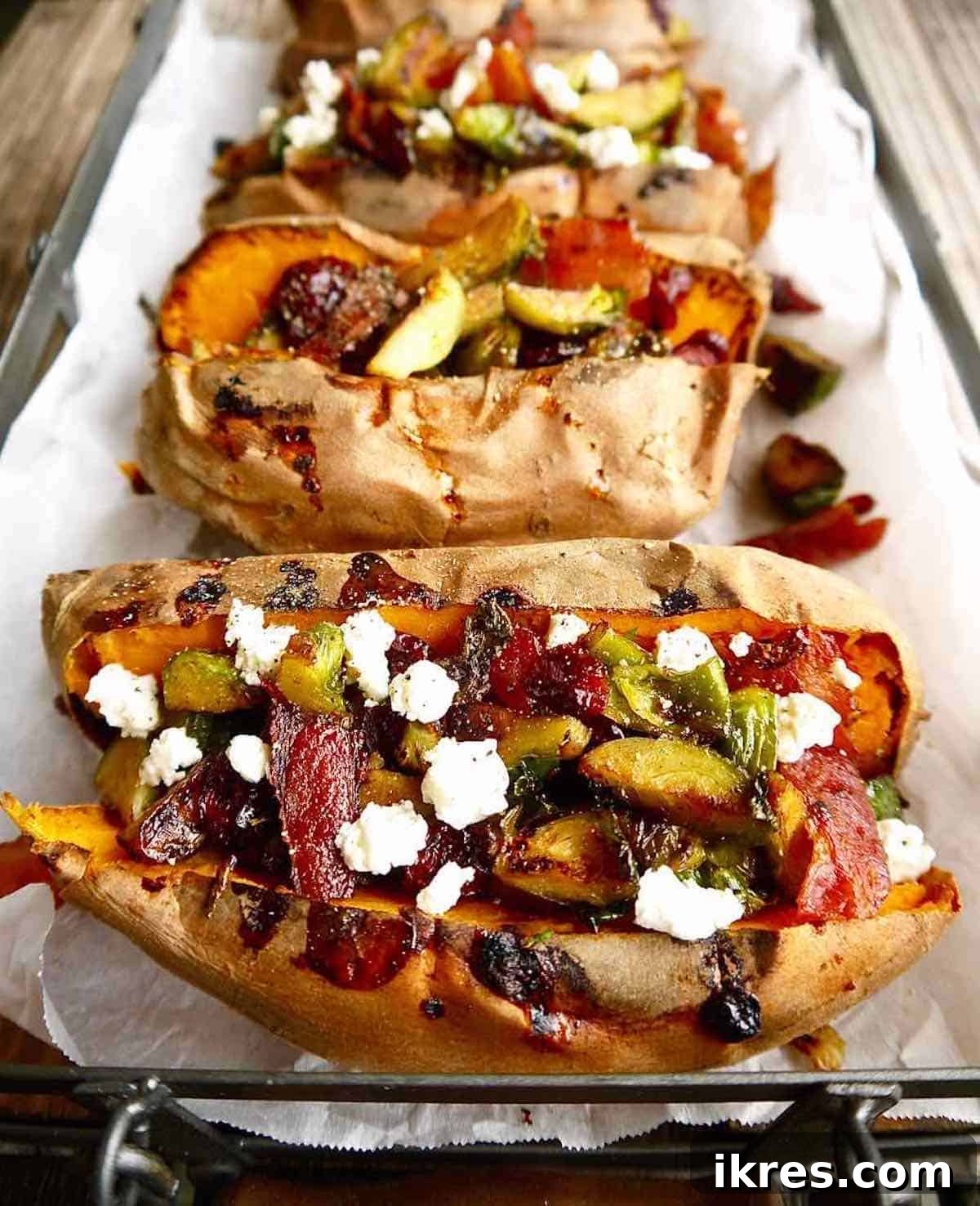 Sweet Potato Boats: Bacon, Brussels & Cranberry 6 A trio of stuffed sweet potatoes, generously filled with a vibrant mixture of Brussels sprouts, bacon, and cranberries, showcasing the rich textures and colors.