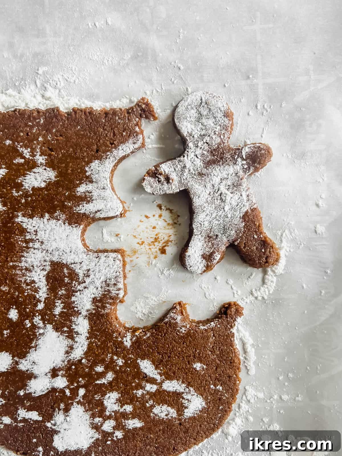 Gingerbread man cut out in the dough.