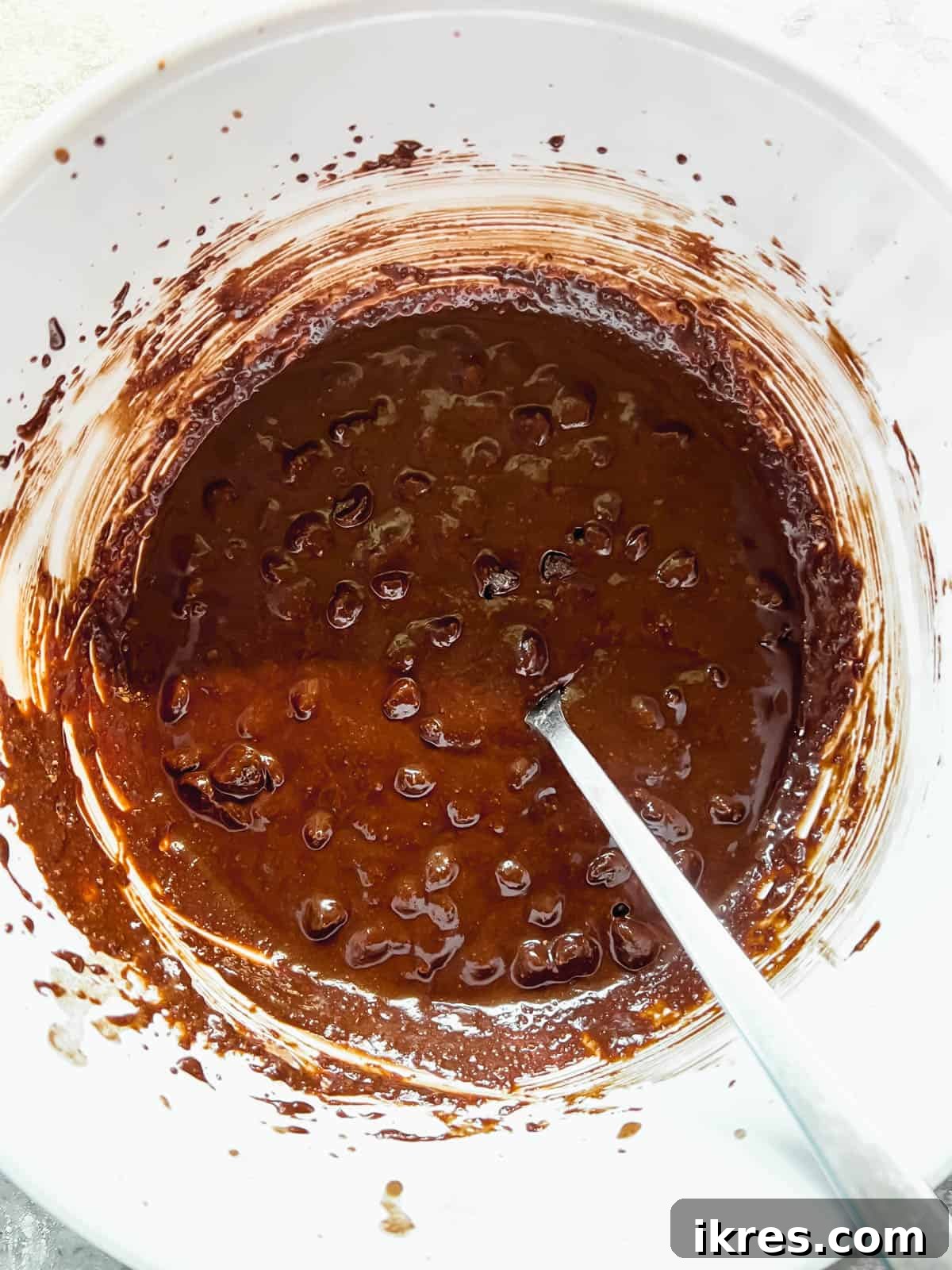 Decadent Paleo Gluten-Free Double Chocolate Chip Cookies 7 Wet and dry ingredients for cookies mixed together in a bowl, ready for chocolate chips.