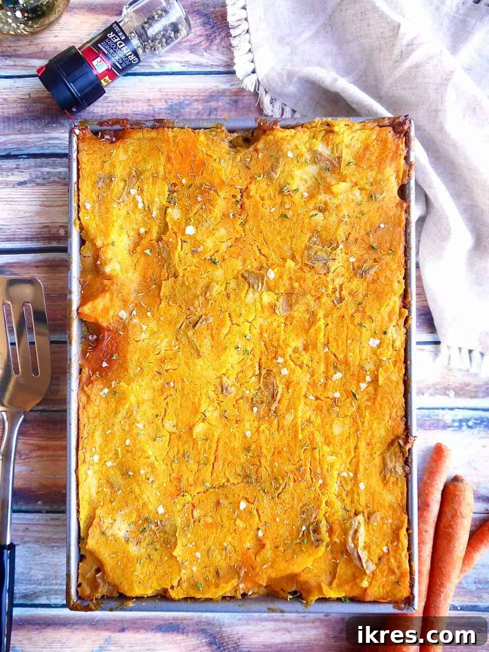 The fully baked Butternut Squash Shepherd's Pie, golden brown and bubbling with savory filling, fresh out of the oven in a large glass baking dish.