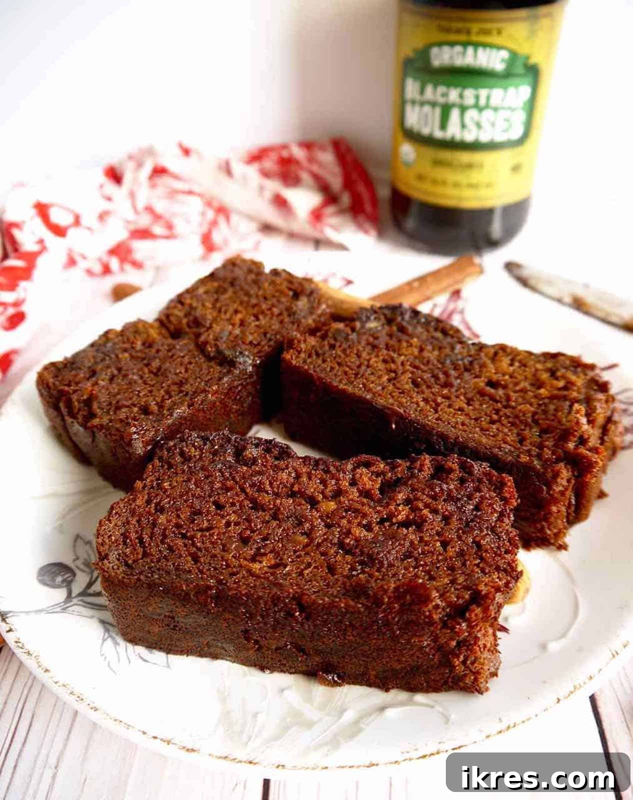 A perfectly baked slice of paleo gingerbread loaf on a clean white plate, ready to be enjoyed.