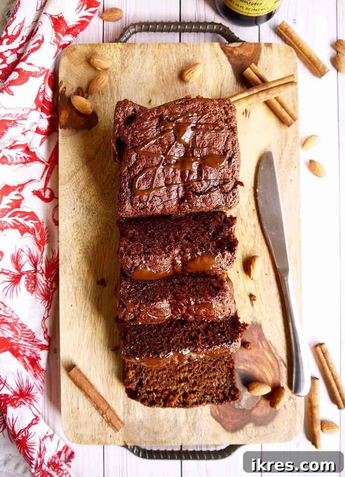 Generous slices of gluten-free gingerbread banana bread arranged on a white serving tray.