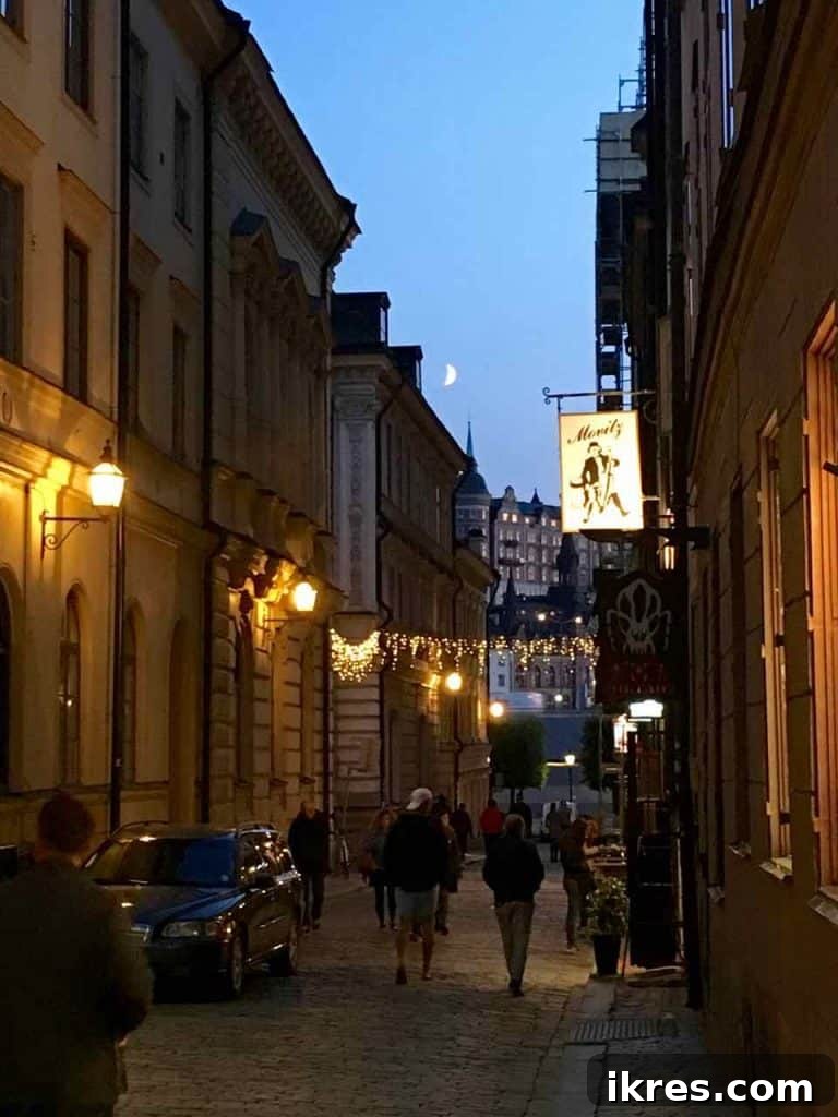 Stockholm: Sweden's Midnight Sun Capital 8 A beautiful night view of a street in Gamla Stan, Stockholm, with warm lights illuminating the cobblestones.