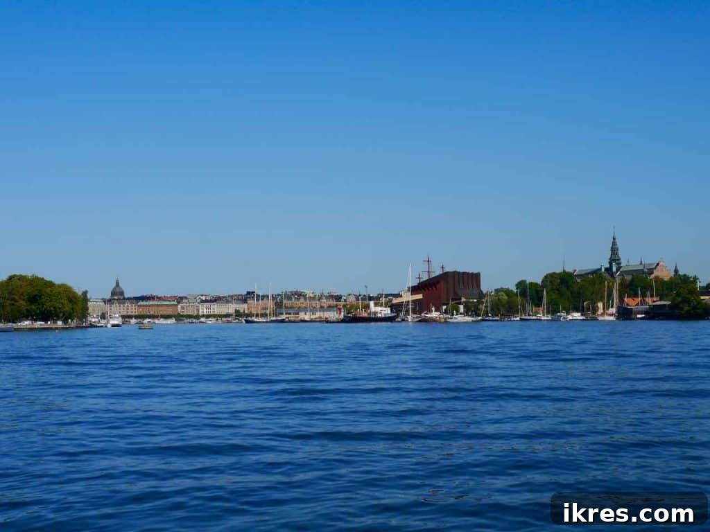 Stockholm: Sweden's Midnight Sun Capital 13 The distinctive red building of the Vasa Museum seen from the water, with three ship masts emerging from its roof.