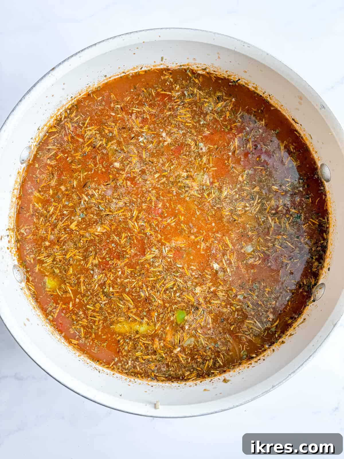 Hearty Homemade Tomato Vegetable Soup Recipe 5 Tomato sauce, bone broth and herbs added to the initial sauteed vegetables in the pot.