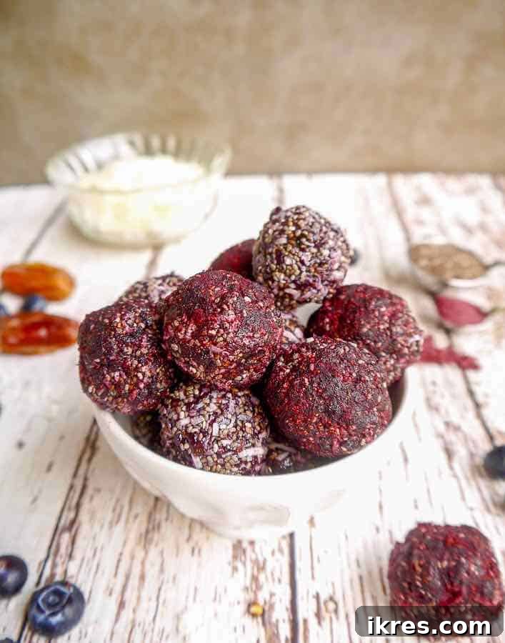 Blueberry Date Energy Bites Paleo Vegan 5 Close-up of a Blueberry Date Energy Ball, showcasing the vibrant blueberry powder.