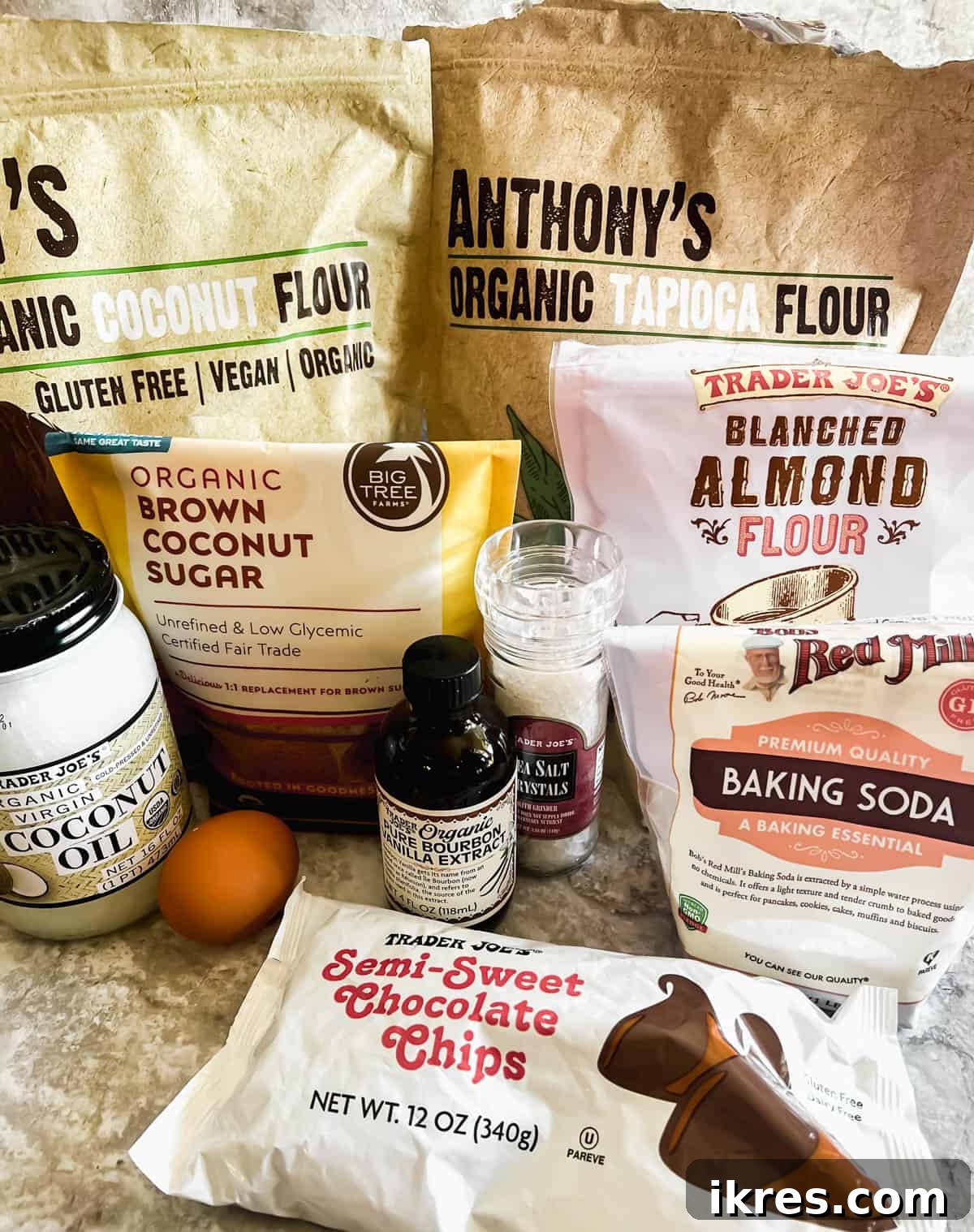 Strawberry Chocolate Chip Paleo Delights 4 A collection of the primary dry and wet ingredients laid out for making Paleo Strawberry Chocolate Chip Cookies, including flours, sugar, and coconut oil.