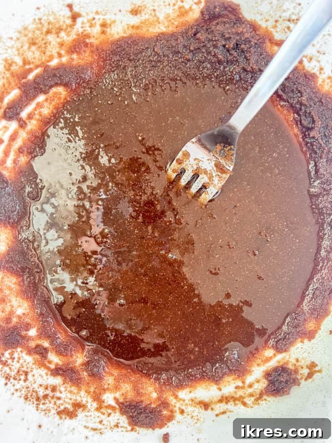 Strawberry Chocolate Chip Paleo Delights 6 Wet ingredients (coconut oil, coconut sugar, egg, vanilla) thoroughly mixed in a bowl.