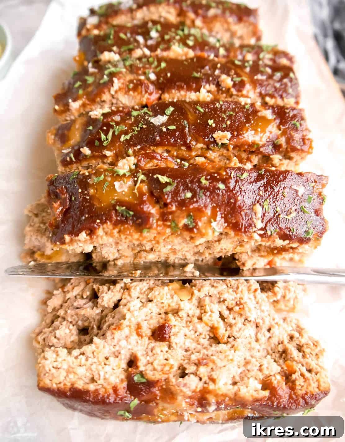 Succulent slices of paleo meatloaf arranged neatly on a serving dish, highlighting its moist and rich interior.
