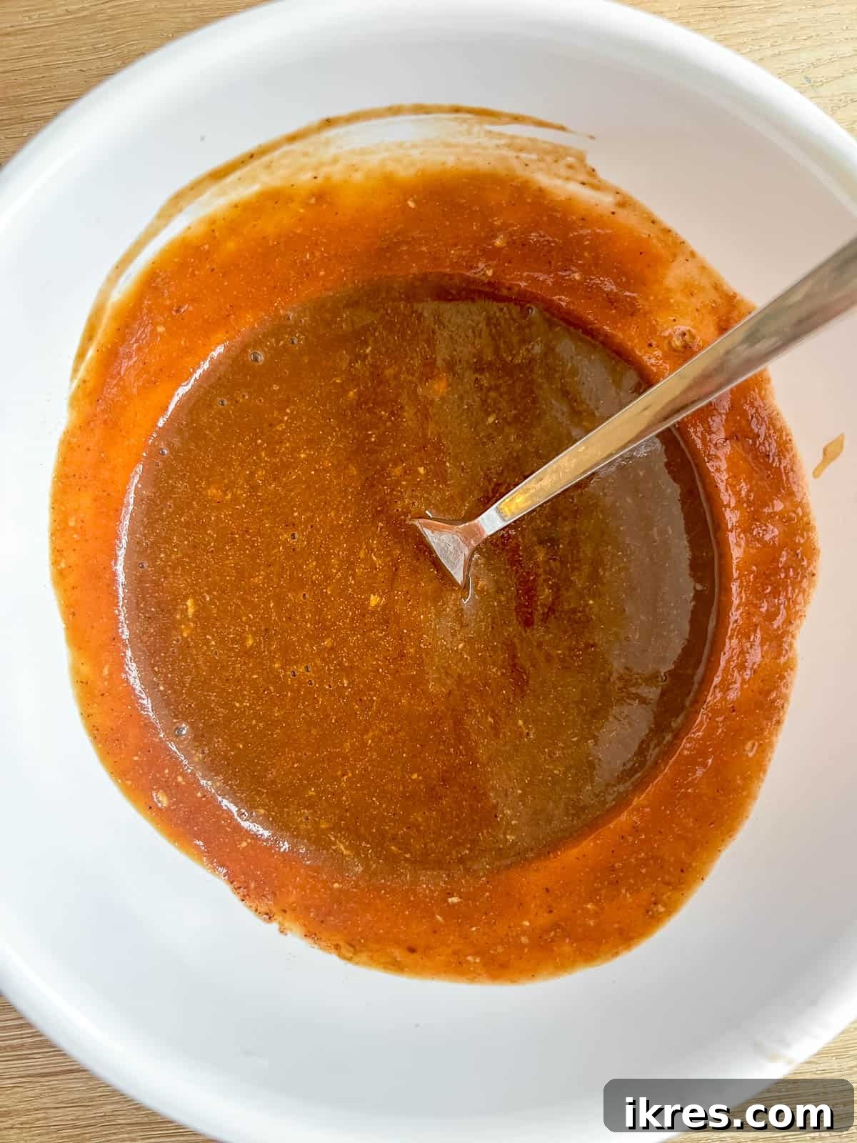 All the sauce ingredients combined in a small bowl, forming a rich, reddish-brown mixture.
