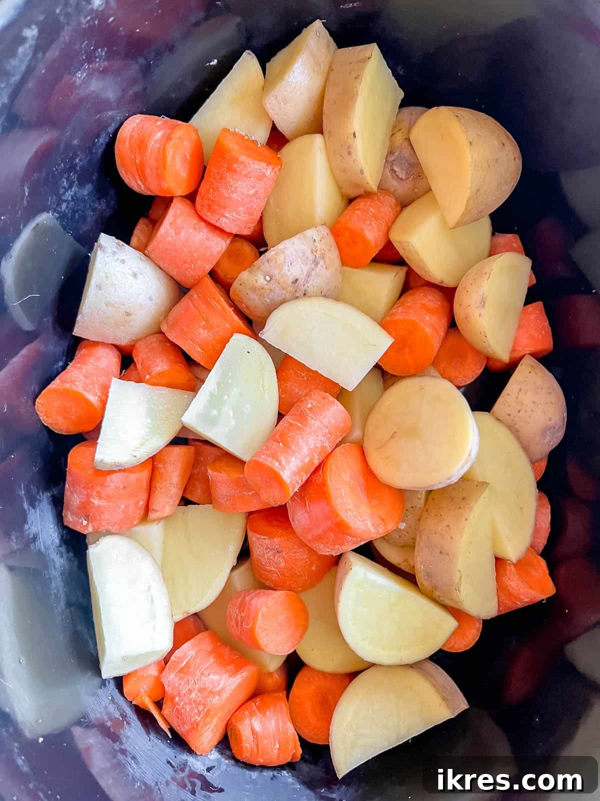 Hearty Slow Cooker Paleo Irish Beef Stew Gluten Free Whole30 5 Carrot and potatoes in crock pot.