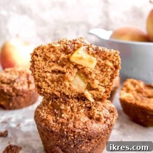 Nourishing Paleo Apple Muffins 7 Paleo apple muffins stacked on top of each other.