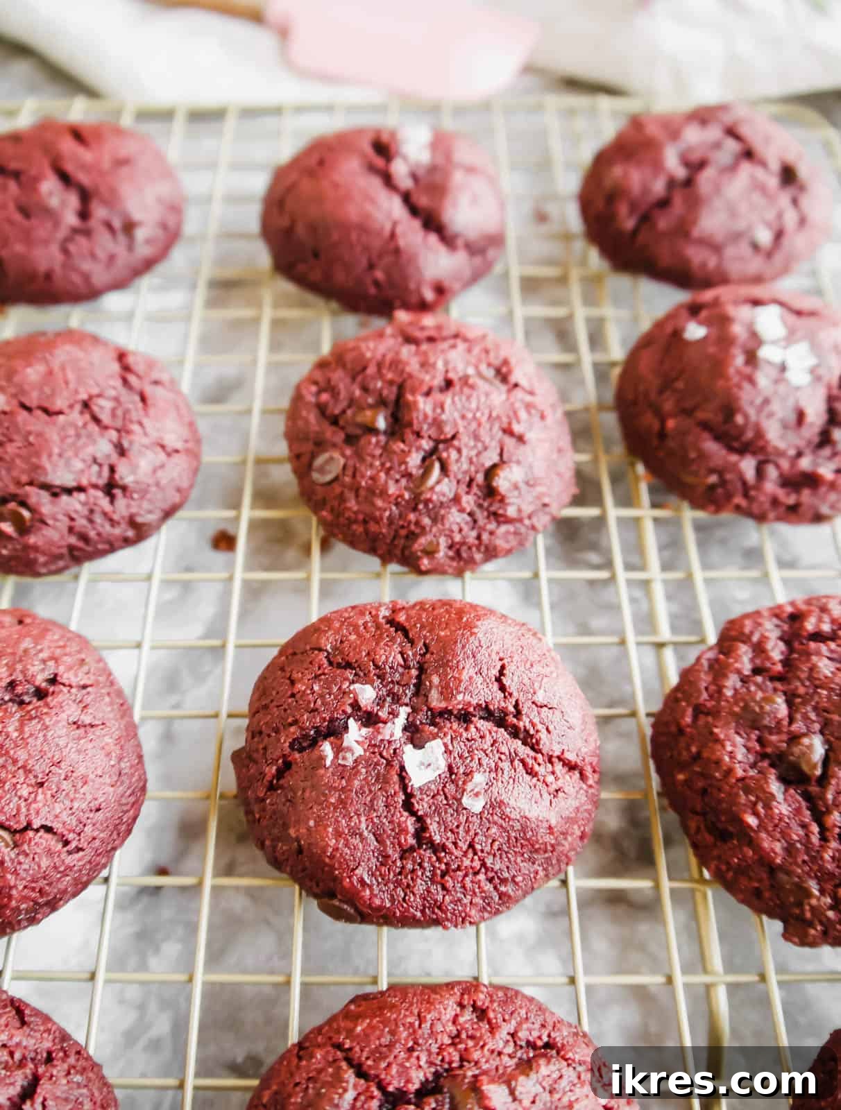 Irresistible Gluten-Free Red Velvet Delights 2 Gluten-free red velvet cookies artfully arranged on a cooling rack, showcasing their vibrant red hue and delicious texture.