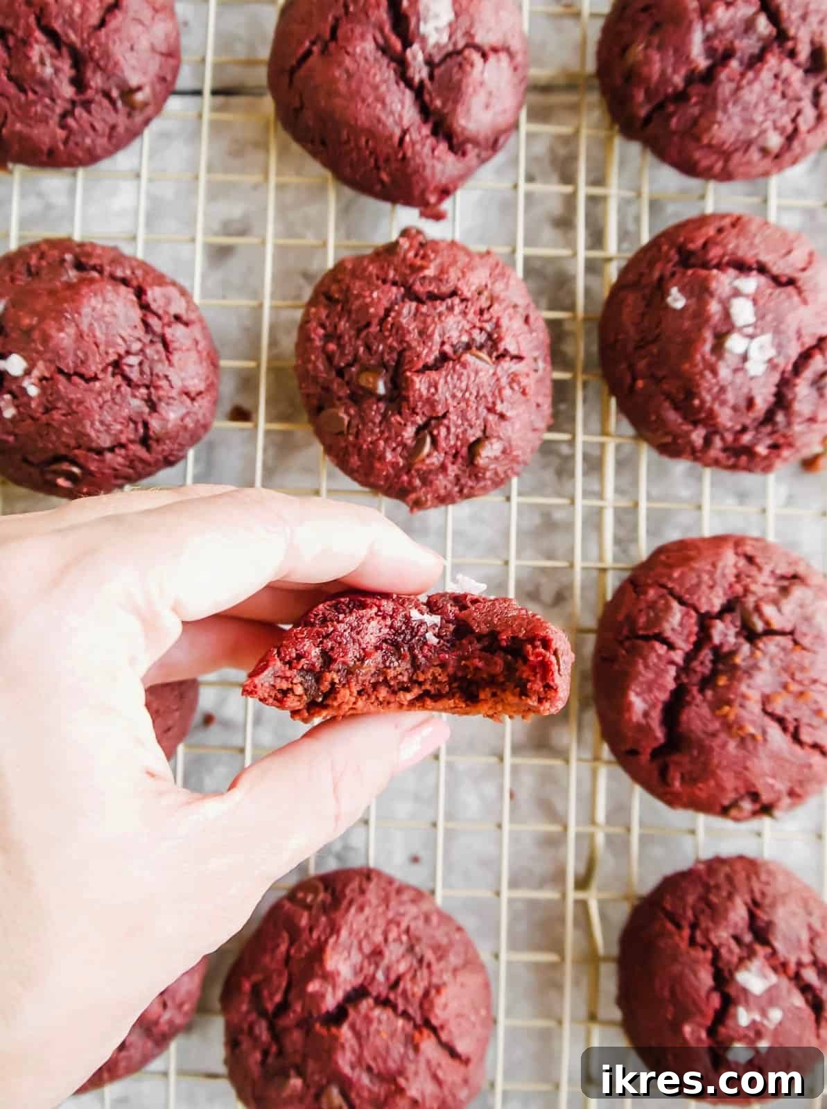 Irresistible Gluten-Free Red Velvet Delights 3 A perfectly baked gluten-free red velvet cookie with a delicious bite taken out, showing its moist and tender interior.