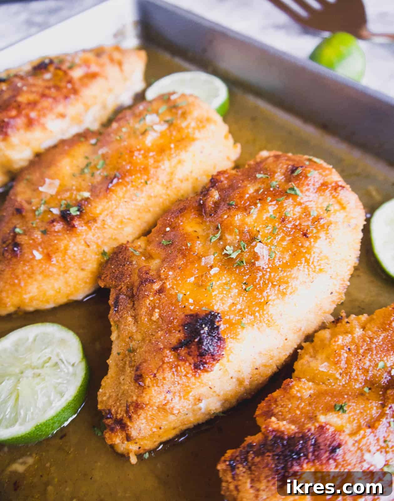 Maple lime chicken, beautifully baked and glistening with sauce, just removed from the oven and ready to serve.