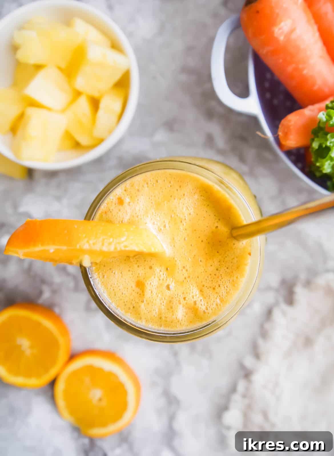 A mason jar filled with freshly made Kale and Carrot Juice, ready to be enjoyed.