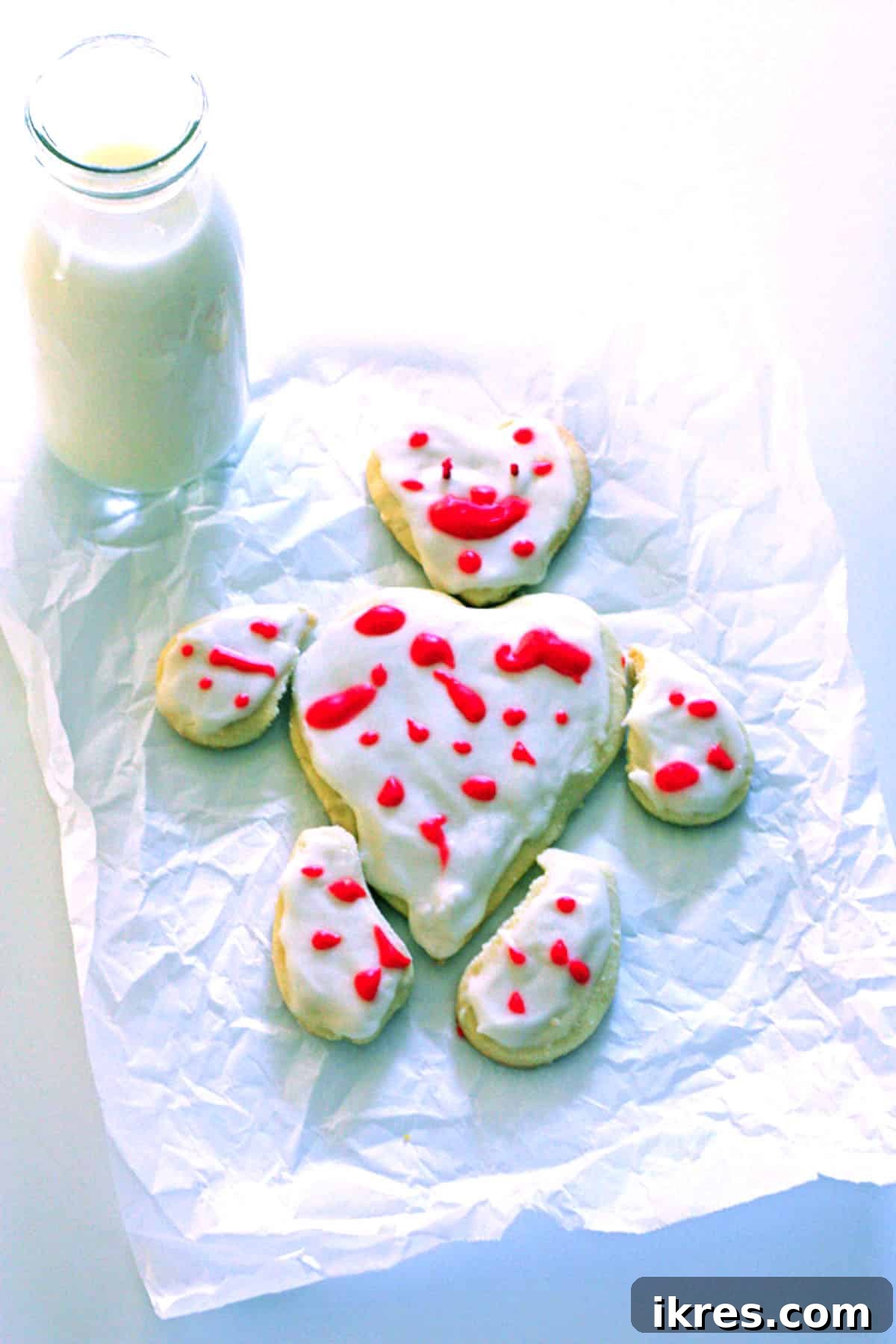 A unique bear-shaped and a classic heart-shaped Valentine's Day cookie, showcasing creative decoration.