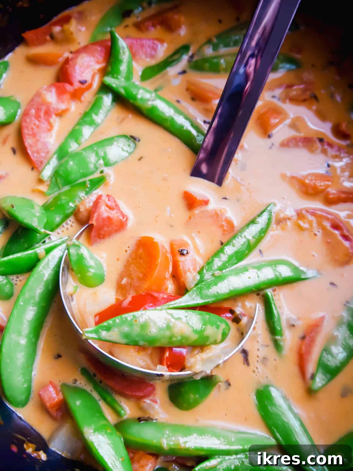 Plant-Based Paleo Thai Red Curry 10 Adding fresh, vibrant snap peas to the almost-finished paleo Thai red curry for a final touch of crispness.