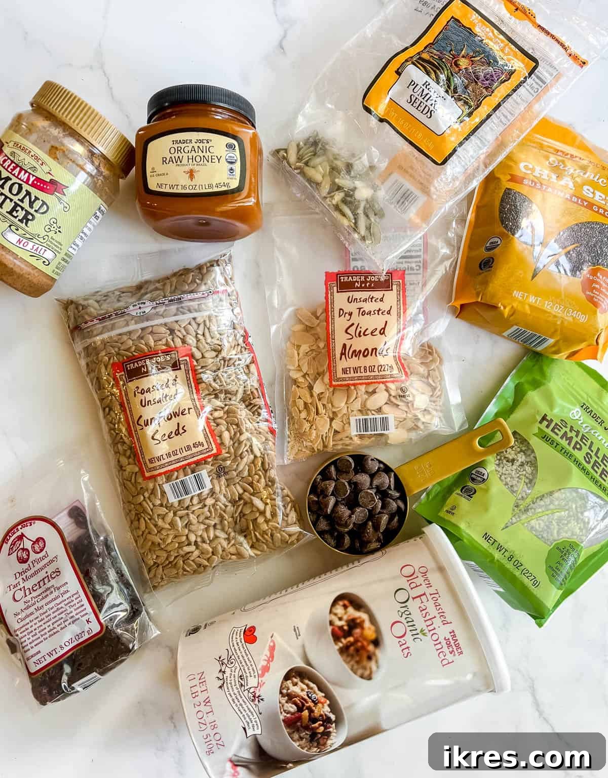 Effortless Gluten-Free Almond Butter Energy Bars 3 Ingredients needed to make homemade gluten free granola bars, laid out on a surface.