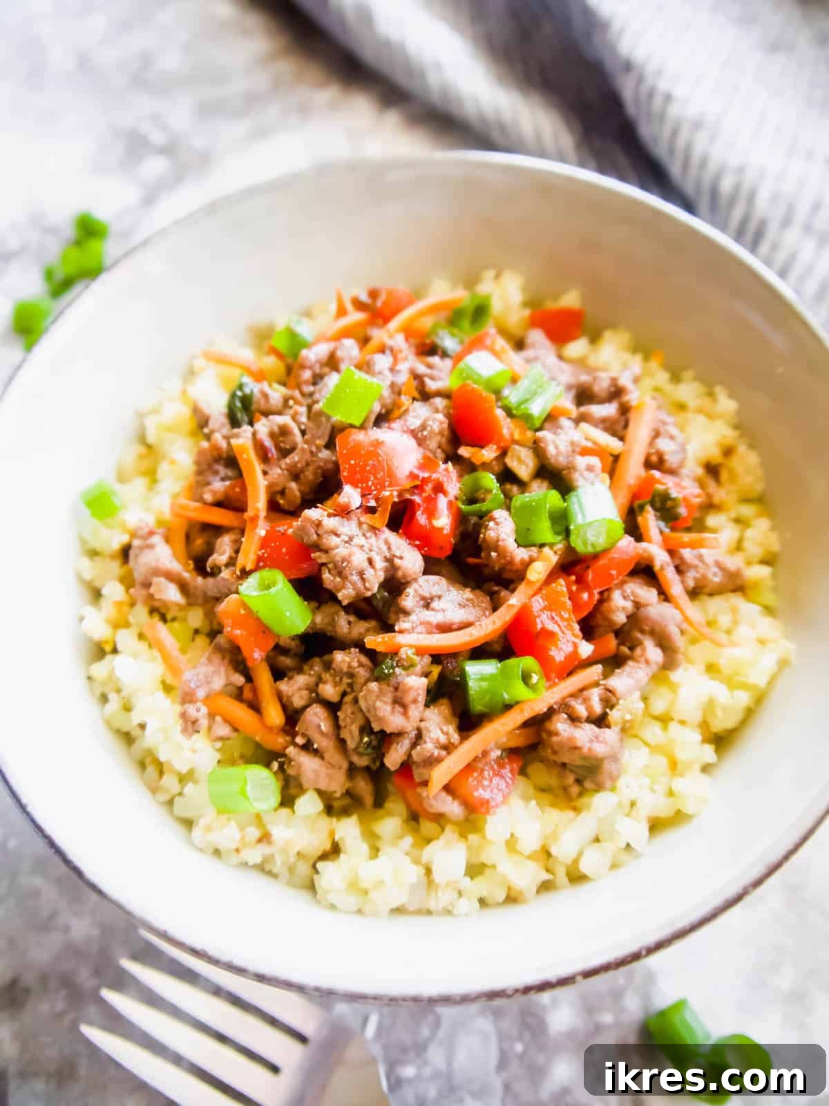 Side view of a Korean ground beef bowl, showcasing the rich colors and textures of the dish.