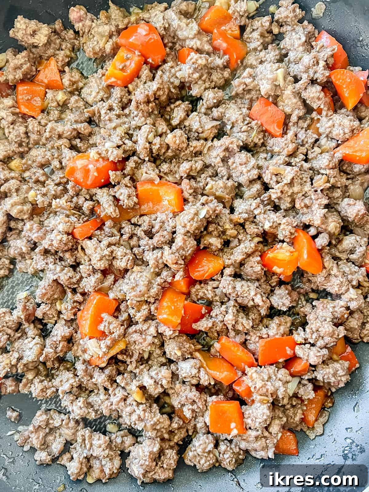 Lean ground beef browning in a hot frying pan, ready to be broken into crumbles.