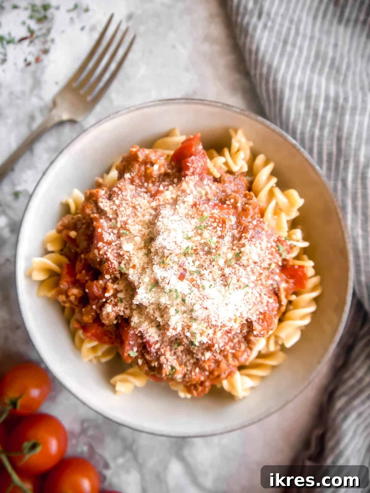 Bold Homemade Bolognese 5 Spicy meat sauce on top of pasta with Parmesan on top.