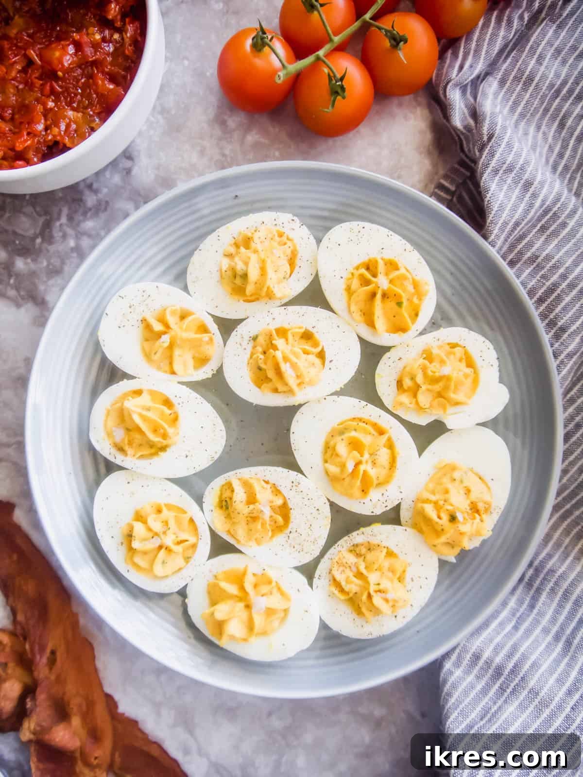 Ingredients for Paleo Deviled Eggs and Tomato Bacon Jam laid out for preparation.