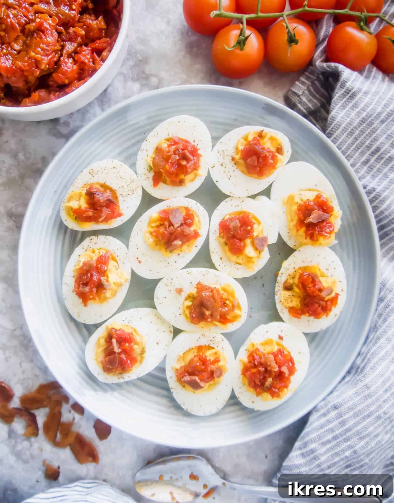 Freshly boiled eggs and the rich Tomato Bacon Jam, essential components for this Paleo appetizer.