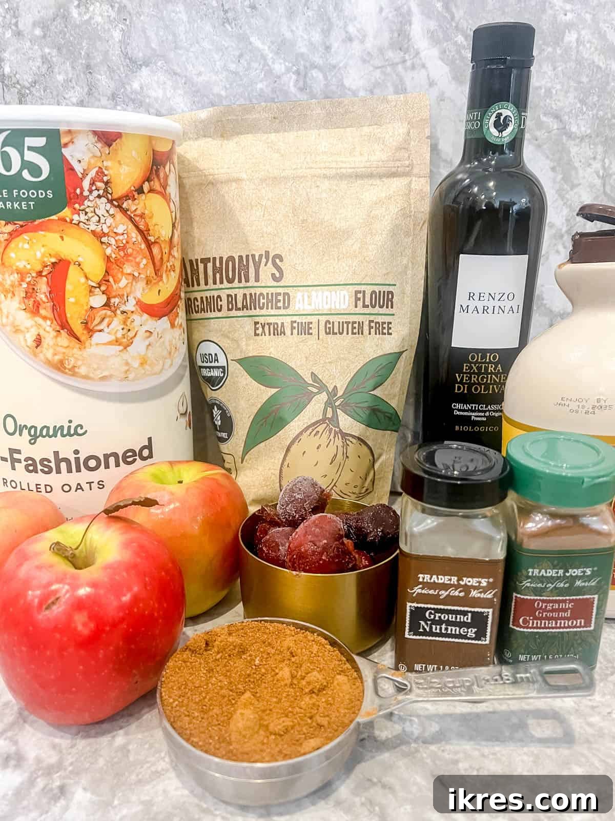 Wholesome Gluten Free Vegan Apple Cherry Bake 3 A flat lay photograph showcasing the fresh ingredients required to make the gluten-free cherry crisp, including apples, cherries, oats, and spices.