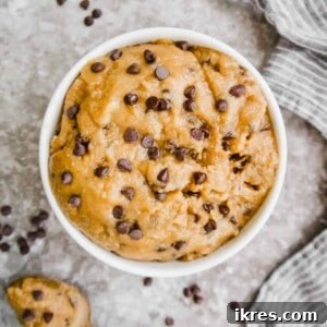 A scoopable bowl of gluten-free edible cookie dough, rich with chocolate chips.