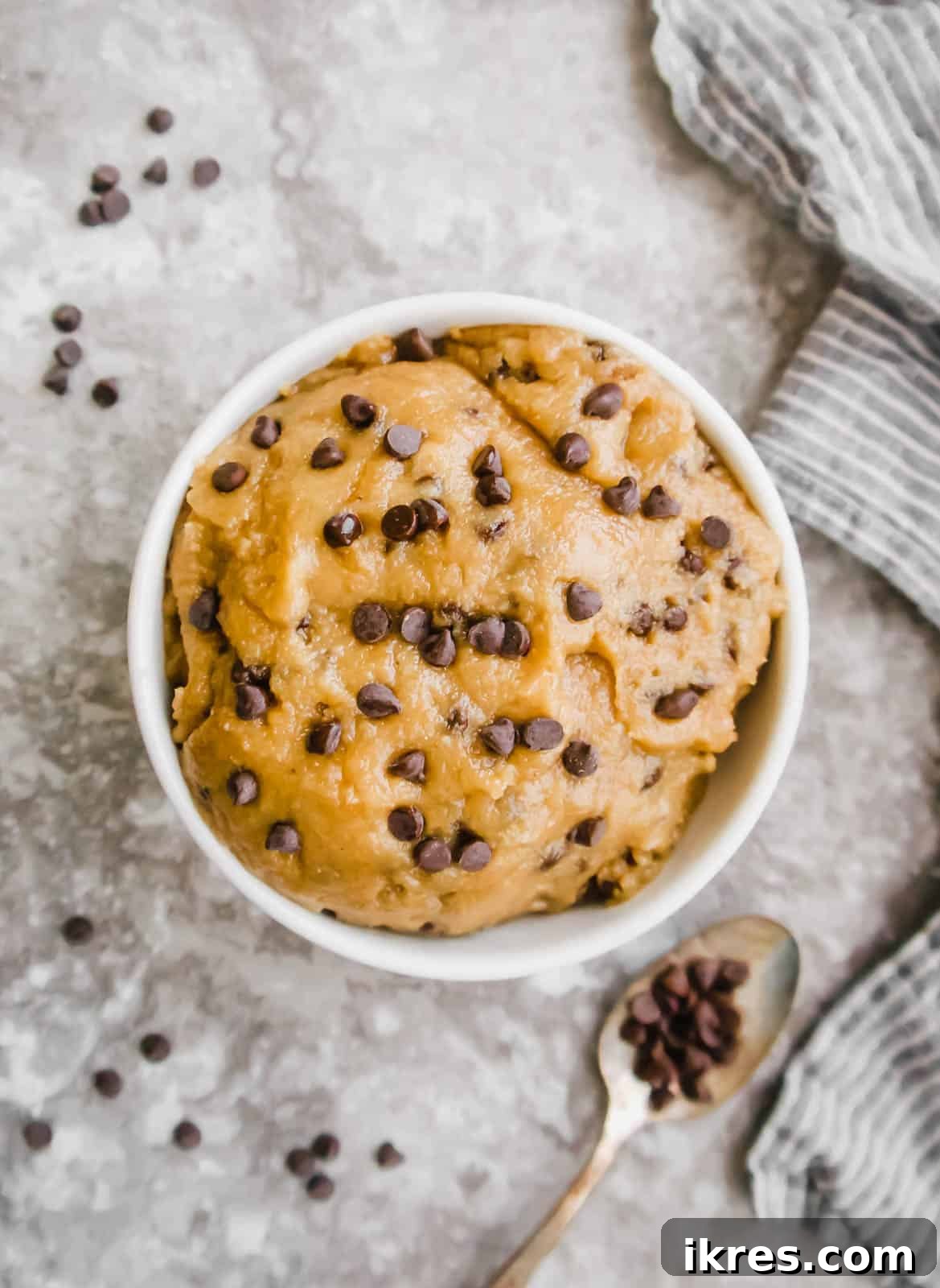 Guilt-Free Gluten-Free Vegan Paleo Cookie Dough 7 A large, inviting bowl filled to the brim with creamy Vegan cookie dough, generously studded with glistening chocolate chips, presented beautifully and ready to be savored raw.