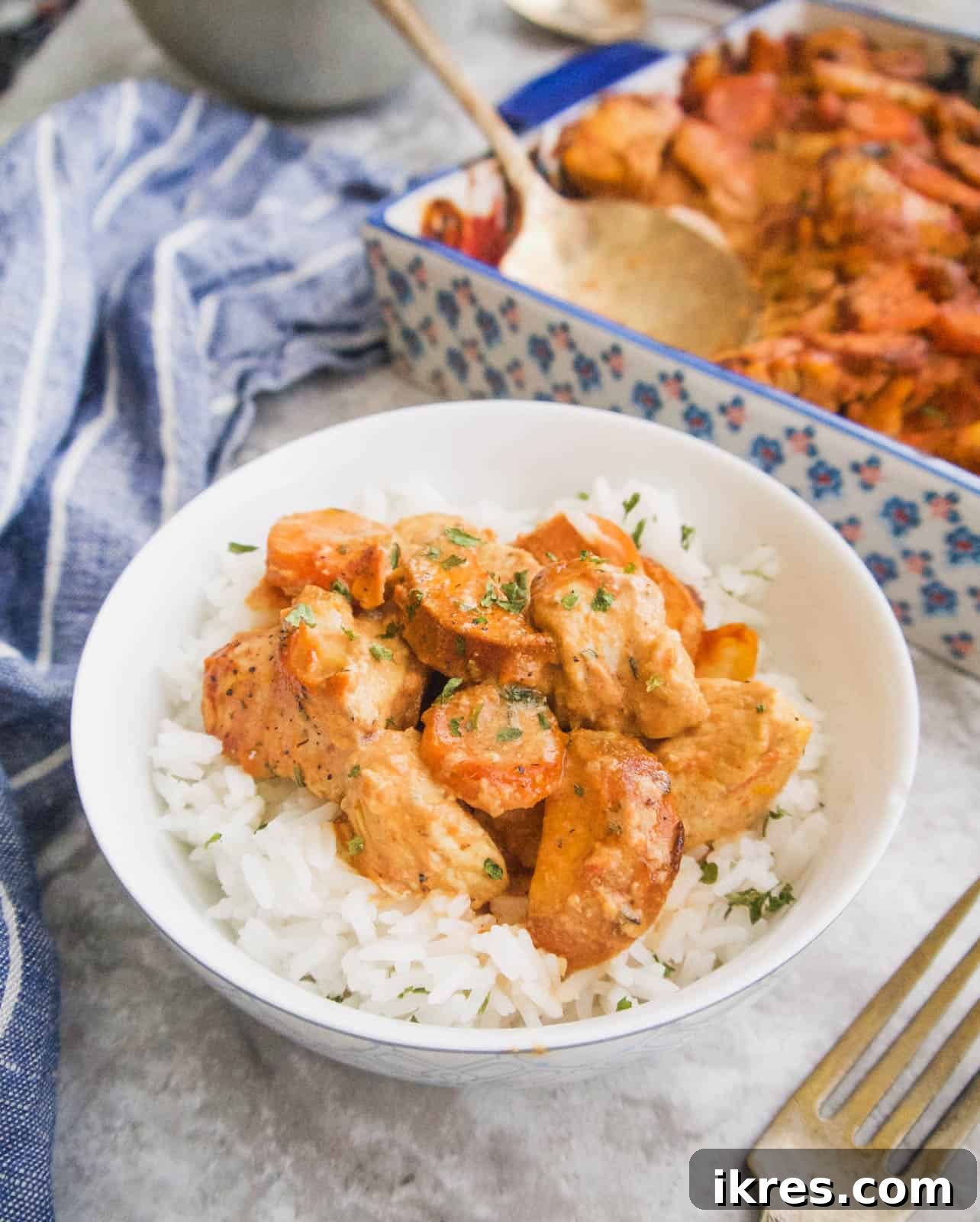 Zesty Dairy-Free Chicken Bake 2 A delicious Dairy-Free Chicken Casserole with a rich tomato mustard sauce, garnished and served in a rustic bowl.