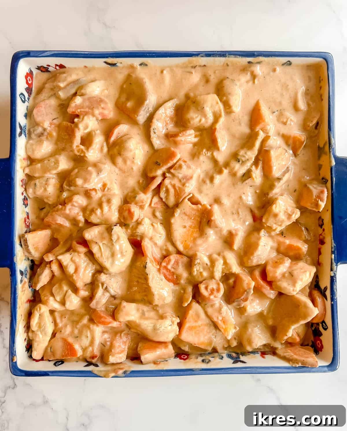 Zesty Dairy-Free Chicken Bake 9 The chicken and vegetable mixture with creamy sauce poured evenly into a baking dish before cooking.