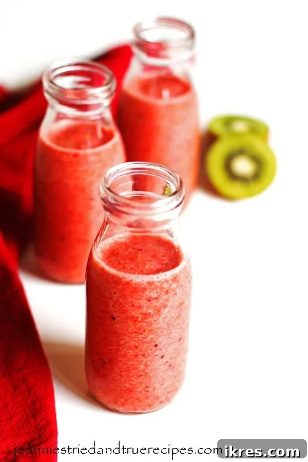 Blended Fruit Bliss 2 Smoothie in three glasses with sliced kiwi and a red napkin next the the glasses