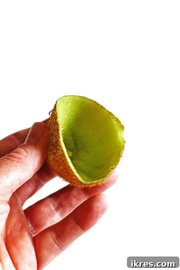 Blended Fruit Bliss 3 Hand holding the skin of a kiwi