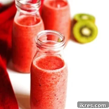 Smoothie in three glasses with sliced kiwi and a red napkin next the the glasses