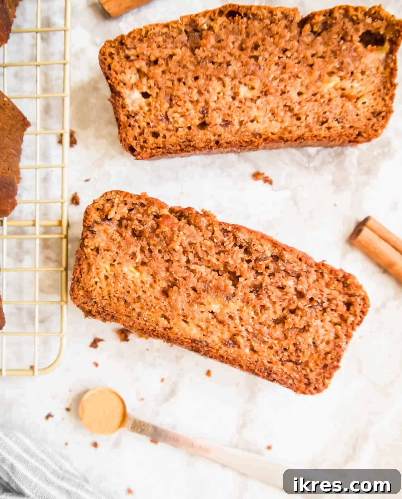 Paleo Banana Bread Grain and Dairy Free 3 Slices of gluten free dairy free banana bread arranged on a wooden table.